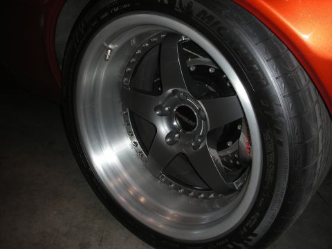 1998 Ford Crown Victoria - Close-up of a custom wheel and tire assembly, showing intricate spoke design and brake components.