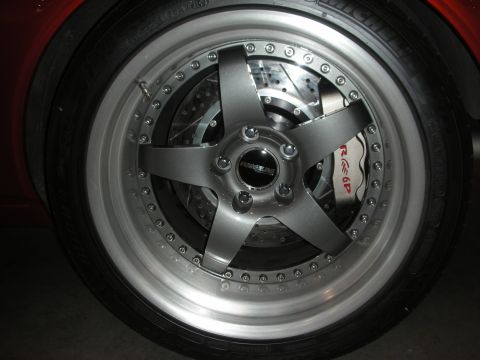 1998 Ford Crown Victoria - A close-up view of a custom five-spoke wheel, red Brembo brake calipers and a Forgestar center cap.