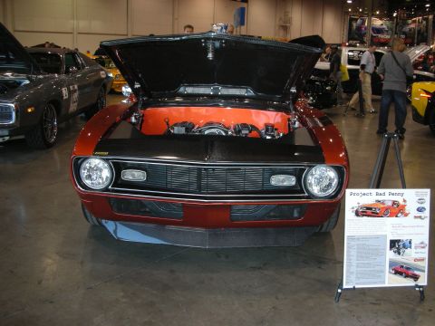 1998 Ford Crown Victoria - Customized muscle car on display with hood open, alongside a descriptive information board.