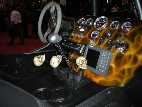 1998 Ford Crown Victoria - A highly customized vehicle interior features skull-shaped gear shift knobs and a flame-painted dashboard with multiple gauges.