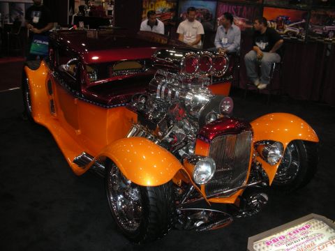 1998 Ford Crown Victoria - Custom hot rod with prominent supercharger and orange fenders on display.