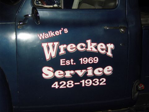 2007 Ford Mustang - A dark blue truck door displays "Walker's Wrecker Service" with a founding date of 1969 and a phone number.