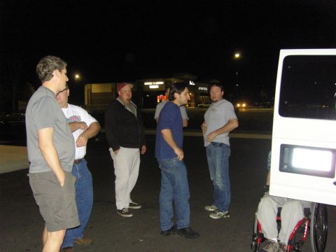 2007 Ford Mustang - A group of men gather in a parking lot at night, with a white van visible on the right side of the frame.