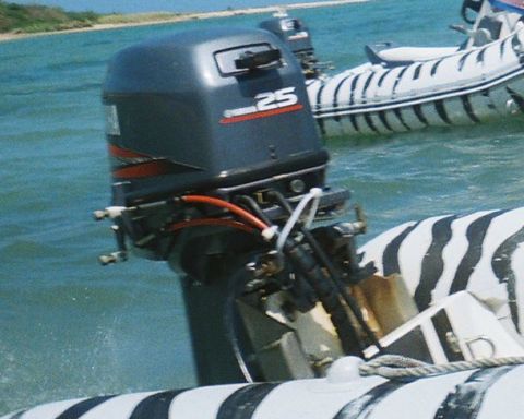 1984 Chevrolet Camaro - A Yamaha 25 horsepower outboard motor is mounted on the stern of a boat with distinctive black and white zebra stripes, with another simila…