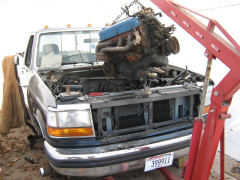 1992 Ford F-250 - Engine removal in progress on a 1992 Ford F-250 truck.