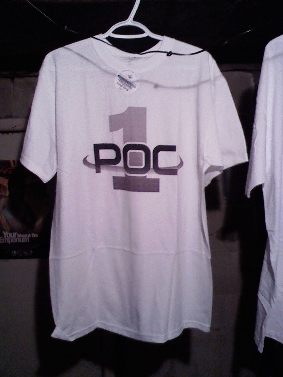 White t-shirt with POC number one graphic on a hanger