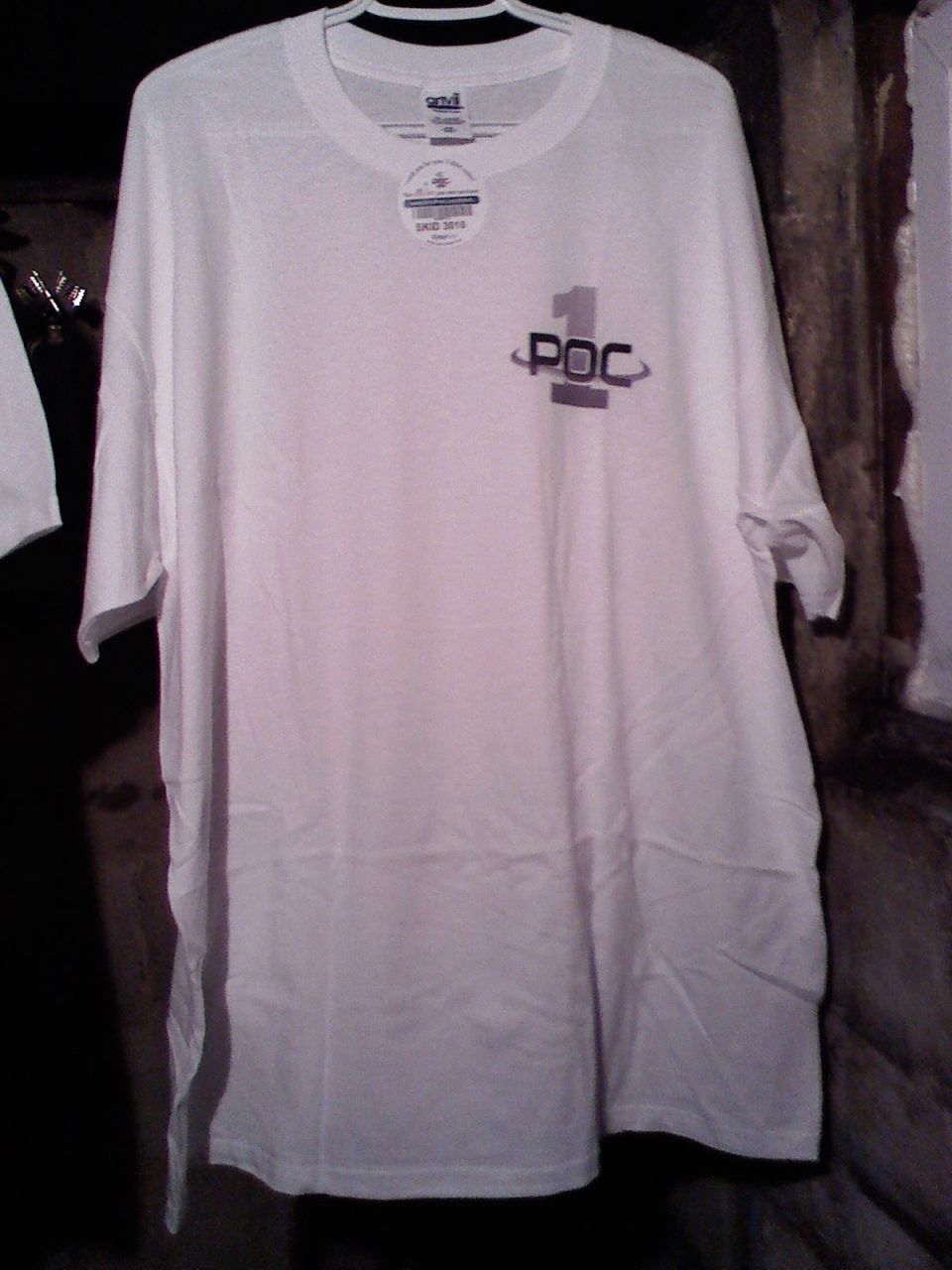 White t-shirt with "1 POC" logo hanging on a hanger