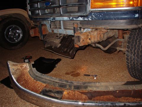 1993 Ford Bronco - The front bumper was dented behind the license plate holder, so I took it off & knocked it out.