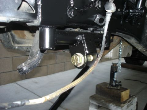 1997 Ford Ranger - Close-up view of vehicle frame and suspension components, supported by a jack.