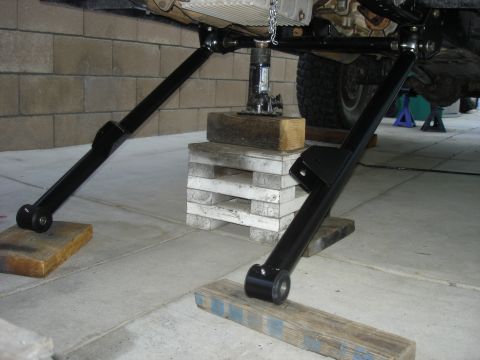 1997 Ford Ranger - The underside of a vehicle is shown with suspension parts and a jack, indicating repair or modification work.
