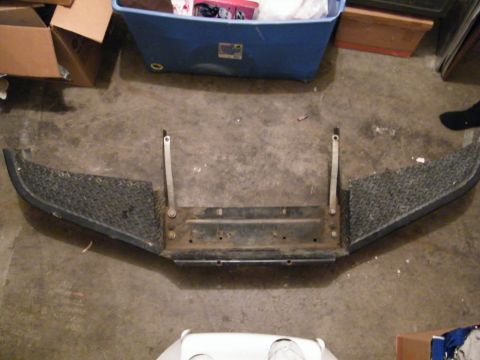 1982 Ford Bronco - A diamond plate bumper with a central mounting bracket is shown on a concrete floor.