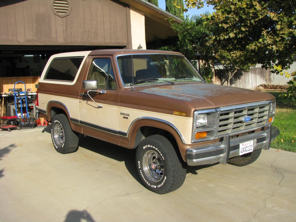 1986 Ford Bronco parked in driveway, brown and tan two-tone paint