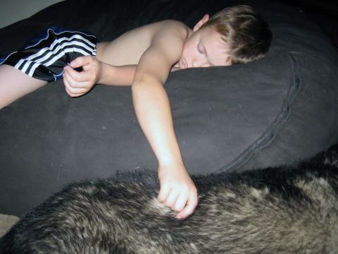1978 Ford Bronco - A young child rests peacefully on a large beanbag chair, with a dog lying beside them.