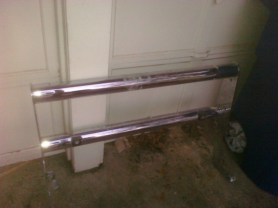 Chrome bumper with two horizontal bars, mounted on a wall