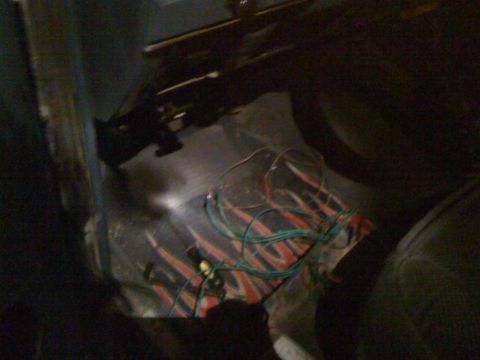 1989 Ford Bronco - The interior floor shows flame decals and a bundle of exposed wires, suggesting custom modifications.