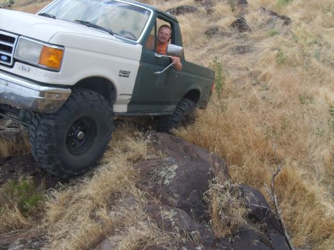 1989 Ford Bronco - Ford F-250 truck navigating rough, rocky terrain off-road.