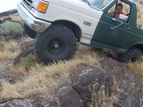 1989 Ford Bronco - This two-tone Ford F-250 is navigating a rocky, off-road trail.