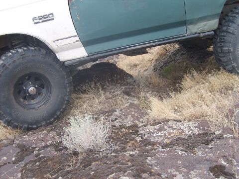 1989 Ford Bronco - This 1989 Ford F-250 is shown off-roading over rocks and dry grass.