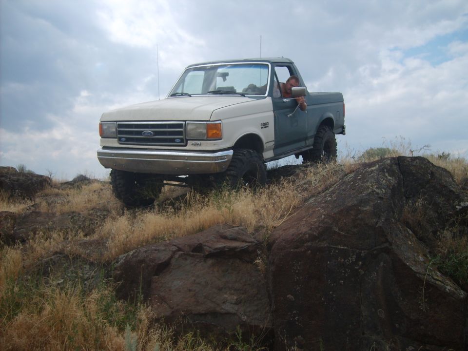 Two-tone Ford F-Series truck on rocky terrain