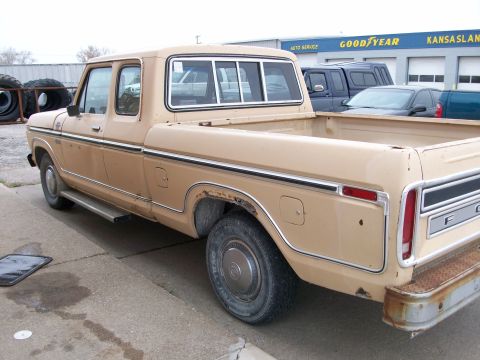 1977 Ford F-150 - This 1977 Ford F-150 pickup truck is shown from the rear passenger side, revealing some rust.