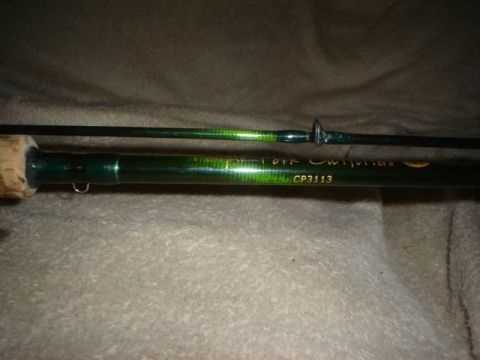 1990 Ford Bronco - A close-up view of a green fishing rod with visible model information.
