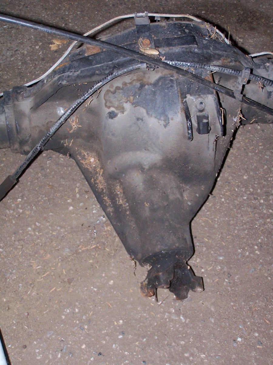 Close-up of a rusty differential housing center section with axle tubes