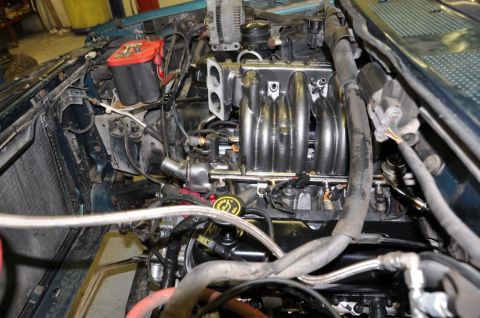 1996 Ford Bronco - Close-up view of a vehicle's engine bay, showing the intake manifold and associated components.