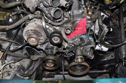 1996 Ford Bronco - Close-up view of an engine bay, focusing on the alternator and pulley system.