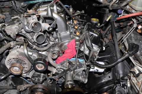 1996 Ford Bronco - Close-up view of a vehicle's engine bay, showing intricate mechanical components and wiring.