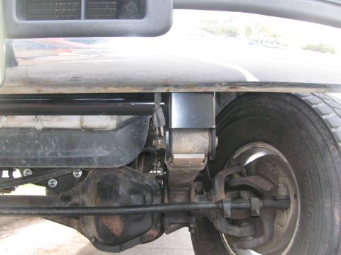 1996 Ford C-350 (Centurion Conversions) - Underside view of a truck's front suspension and a newly installed tow hook bracket.