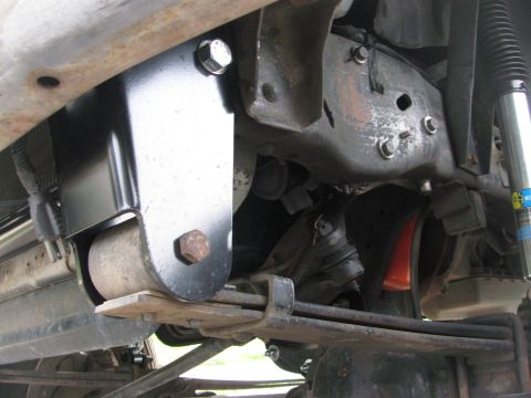 1996 Ford C-350 (Centurion Conversions) - Undercarriage view of a truck's suspension system, showing leaf springs and a shock absorber.