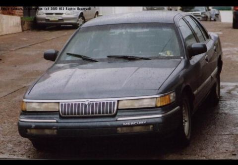 1992 Mercury Grand Marquis - A 1992 Mercury Grand Marquis is shown from the front, with other vehicles visible in the background.
