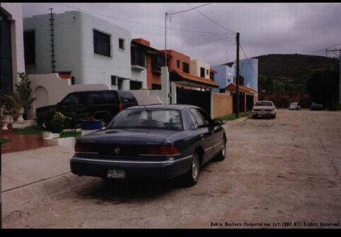 1992 Mercury Grand Marquis - Rear view of a dark blue 1992 Mercury Grand Marquis sedan parked on a residential street.