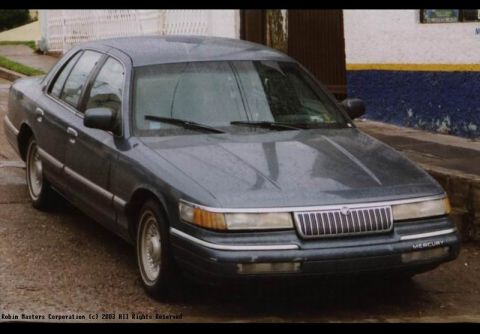 1992 Mercury Grand Marquis - A 1992 Mercury Grand Marquis is shown from the front-right angle on a wet street.