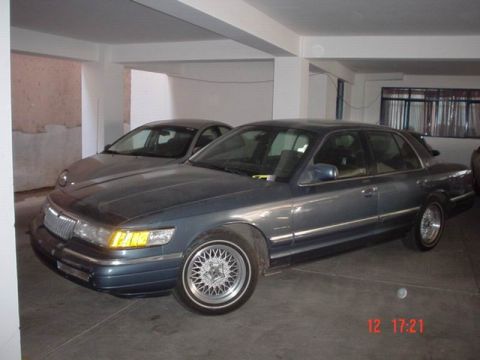 1992 Mercury Grand Marquis - Two cars parked indoors, one is a 1992 Mercury Grand Marquis.