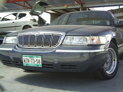 1992 Mercury Grand Marquis - Front view of a 1992 Mercury Grand Marquis with a prominent chrome grille and license plate.