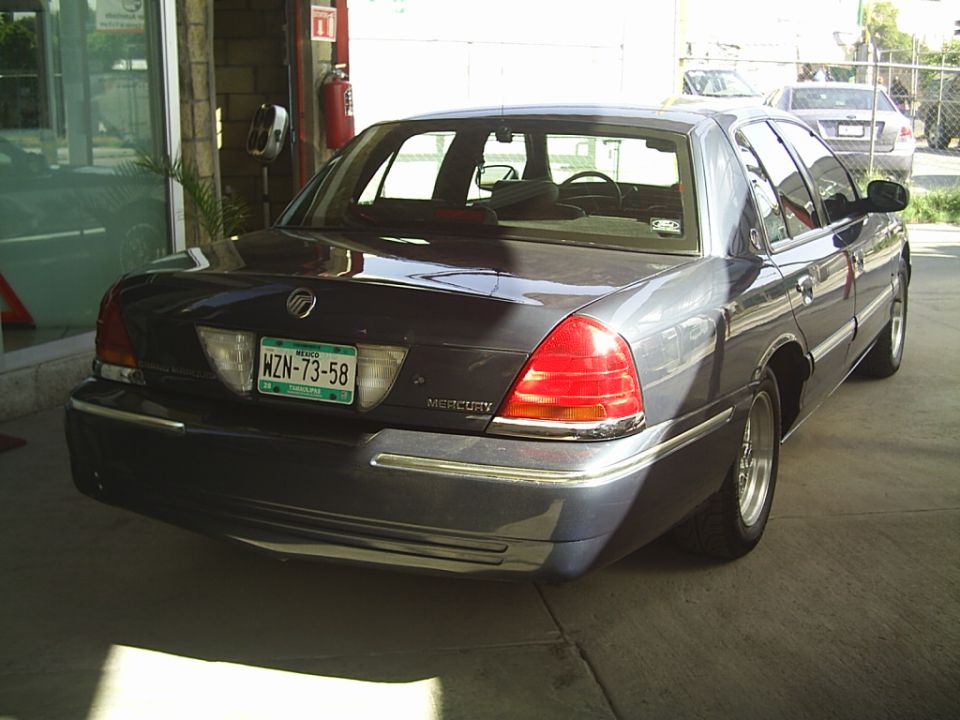 Dark blue sedan rear view. License plate WZN-73-58