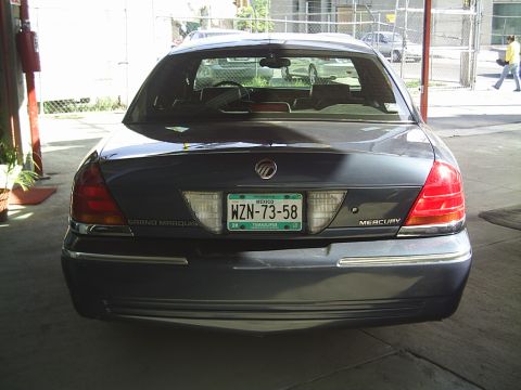1992 Mercury Grand Marquis - Rear view of a Mercury Grand Marquis, likely from the early 2000s, showing its taillights and license plate.