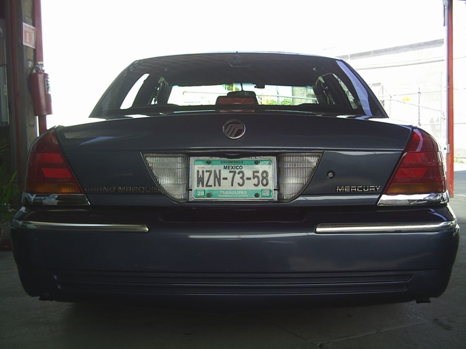 Rear view of a dark blue Mercury Grand Marquis. License plate reads WZN-73-58