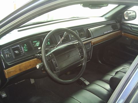 1992 Mercury Grand Marquis - The interior of a 1992 Mercury Grand Marquis shows a digital display and wood accents.