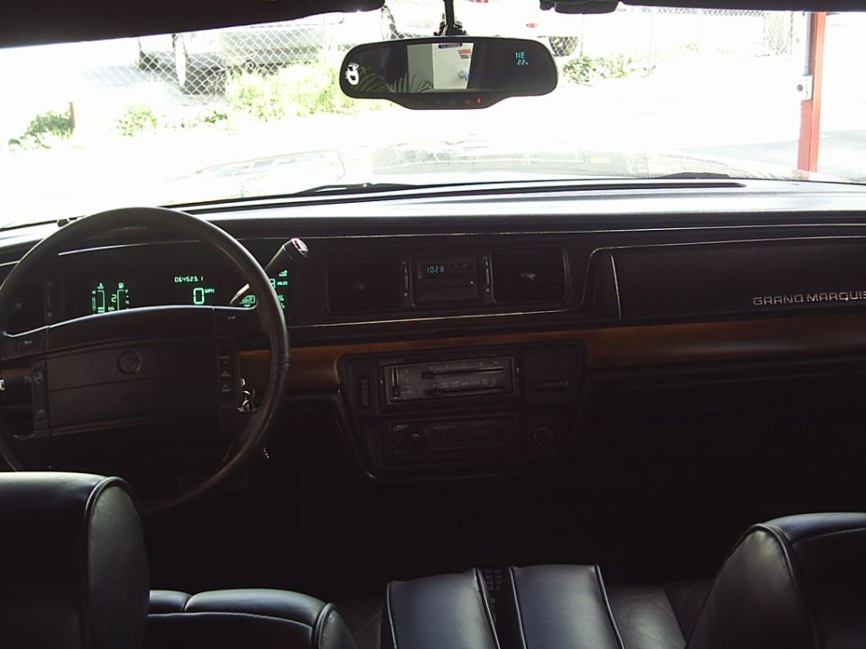 1992 Mercury Grand Marquis interior with digital dashboard, wood trim, and cassette player