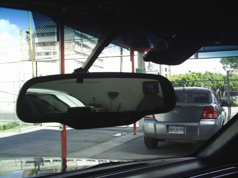 1992 Mercury Grand Marquis - A silver sedan is parked outside, seen from the interior of another vehicle. The license plate is visible.