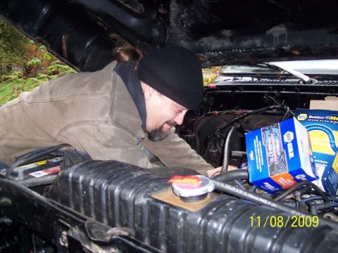 1989 Ford Bronco - A person works on the engine of a vehicle, with a date stamp of 11/08/2009 visible.
