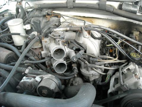 1992 Ford Bronco - Here we can see what we are dealing with. I removed the air intake hoses already and I have been soaking the housing bolts for three days w…