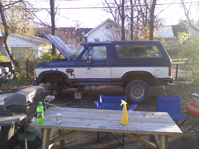 1986 Ford Bronco side view, hood open, lifted on jacks