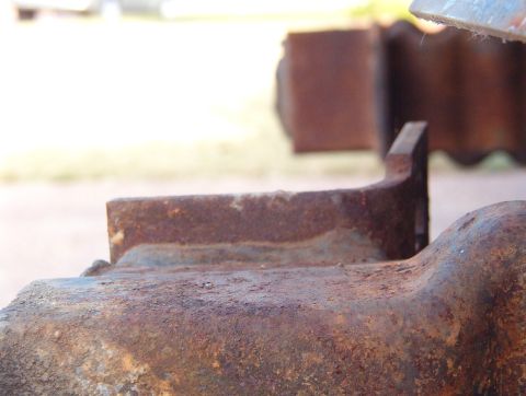 1993 Ford Bronco - The front bumper mounting tabs were bent, so I straightened them with a big adjustable wrench.