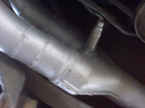 1994 Ford F-150 - Close-up of an exhaust system component with an attached sensor.