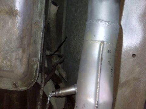 1994 Ford F-150 - Underside view of a vehicle's exhaust system, focusing on an oxygen sensor and pipe.