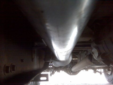 1994 Ford F-150 - Underside view of a truck's exhaust system and rear axle components.