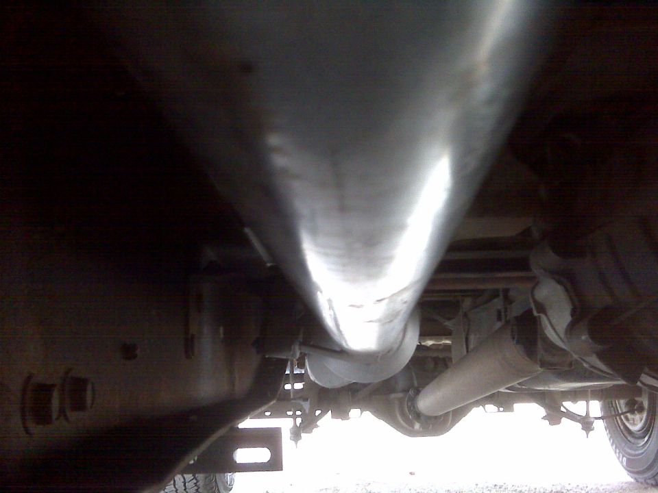 Underside of a truck showing exhaust pipe and rear axle
